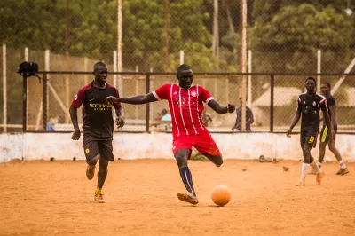 A group of young people play soccer at a youth center in Guinea. Photo: Vincent Tremeau, World Bank