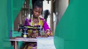 Patrick Funmilayo, a 24-year-old tailor, working with her sewing machine at her home in the neighbourhood of Makoko in Lagos, Nigeria.