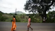 Two women walk a rural road in India