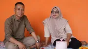 An Indonesian man and woman eat at home