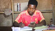 A man uses his smartphone to transfer money