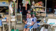 A woman and two girls look at a phone