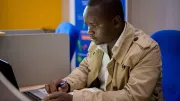 Man on computer, Zimbabwe