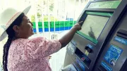 Woman takes cash from an ATM