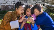 Youth in Bhutan use a smartphone
