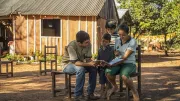 Family reading outdoors, Paraguay