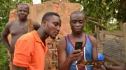 Mobile money users looking at a mobile phone.
