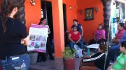 A loan officer sells life insurance to a group of clients as part of a marketing intervention in Mexico.