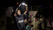 An off-grid electric customer uses a solar lamp.