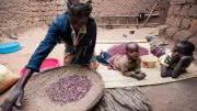 Woman sifting beans in Rwanda