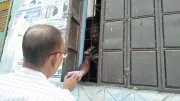 An agent helps a customer in Bangladesh. Photo: Ma-Moni Telecom, Brammonbaria, Bangladesh