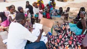 A representative of a microfinance institution meets with prospective borrowers in Siby, Mali.