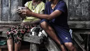 Family uses mobile phone in Philippine village
