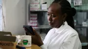 A pharmacist assists a customer in Kenya.