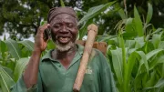 A smallholder farmer in Ghana uses his mobile phone. 