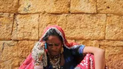 A merchant uses her mobile phone in Jaisalmer, India. 