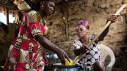 Women in rural Ghana make soup in a clean-energy cookstove their community purchased with a microloan.