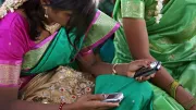 Young woman uses mobile phone in India
